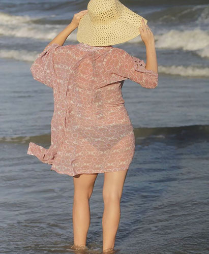 woman wearing a kimono with a swimsuit on the beach