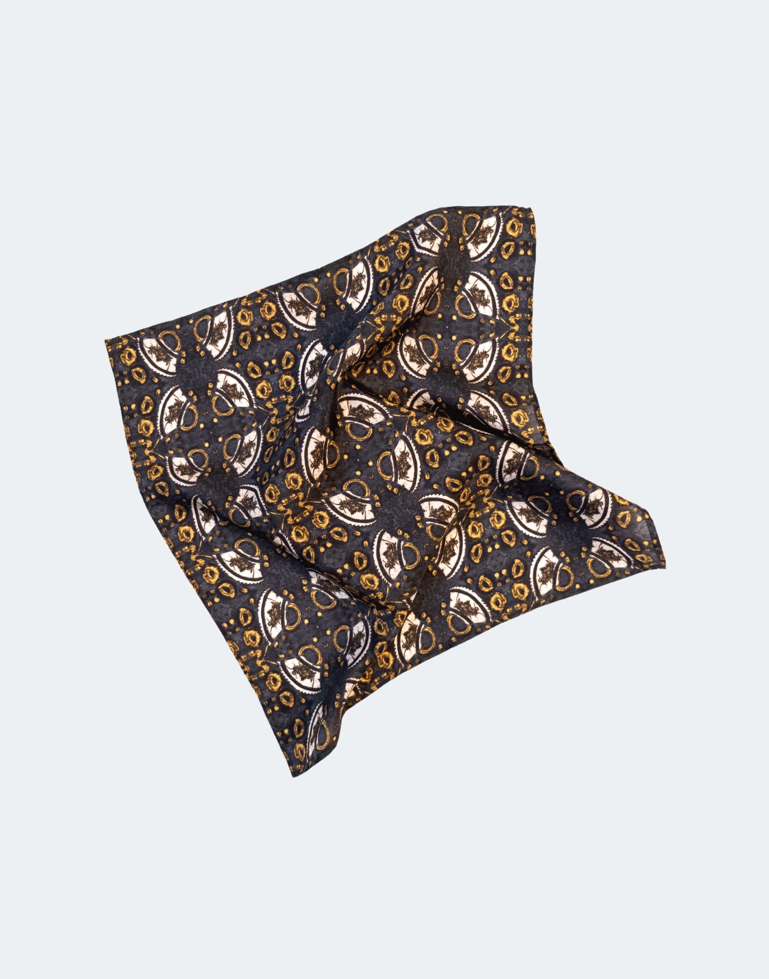 flat laid pocket square with gold and white print across a dark background