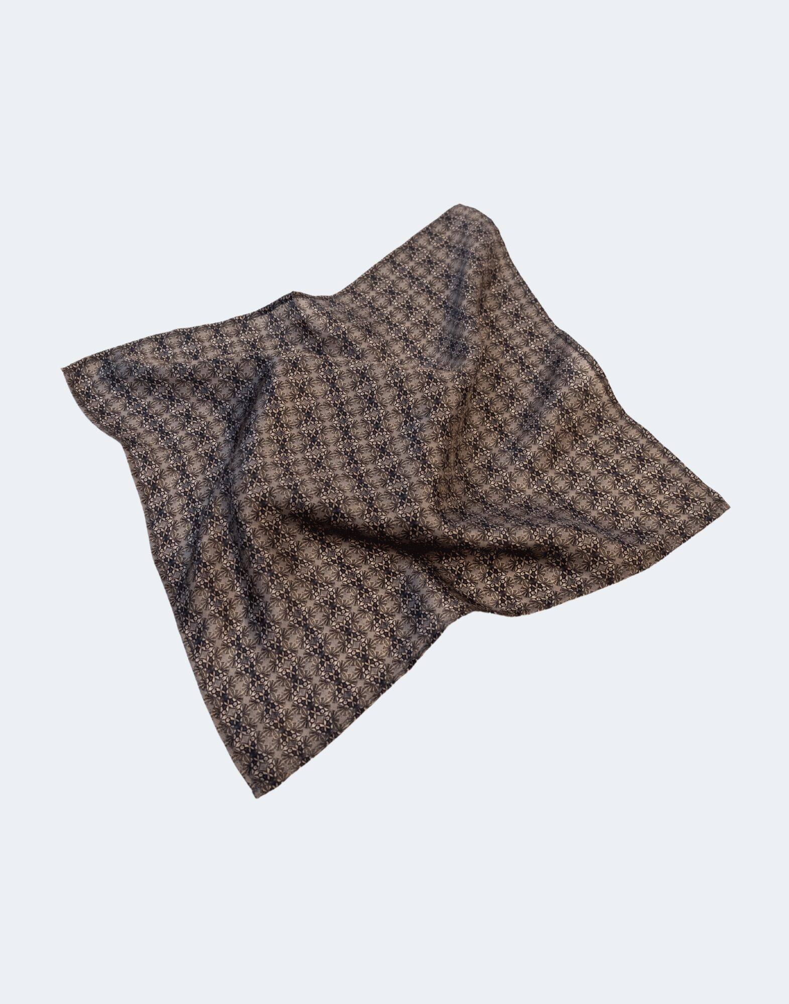 flat laid pocket square with circular pattern in deep browns and blacks